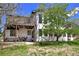 Inviting backyard with outdoor seating area and a second story balcony overlooking the well-maintained lawn at 1673 Woodmoor Dr, Monument, CO 80132