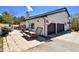 Outdoor patio with a picnic table, lounge chair, grill, hot tub and garage is perfect for relaxation and entertainment at 1673 Woodmoor Dr, Monument, CO 80132