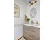 Modern bathroom featuring a stylish vanity, round mirror, and decorative accents at 1673 Woodmoor Dr, Monument, CO 80132