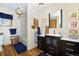 Charming bathroom features tub, wooden cabinets, and framed artwork at 1673 Woodmoor Dr, Monument, CO 80132