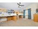 Spacious bedroom with bunk beds, ceiling fan, and carpet flooring at 1673 Woodmoor Dr, Monument, CO 80132