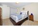 Cozy bedroom featuring a plush bed with stylish floral bedding and a wooden nightstand at 1673 Woodmoor Dr, Monument, CO 80132