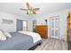 Bedroom features ceiling fan, dresser, and light gray vinyl flooring at 1673 Woodmoor Dr, Monument, CO 80132