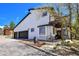 Charming home exterior boasts a two-car garage and a welcoming front porch with rustic decor at 1673 Woodmoor Dr, Monument, CO 80132