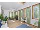 Sunroom-style foyer with brick floor, skylight, and many windows at 1673 Woodmoor Dr, Monument, CO 80132