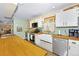 Bright kitchen with white cabinets, wooden countertops, and farmhouse sink at 1673 Woodmoor Dr, Monument, CO 80132