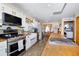 Bright kitchen with white cabinets, wood countertops, and an island at 1673 Woodmoor Dr, Monument, CO 80132
