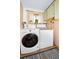 Well-equipped laundry room with washer, dryer, and practical storage solutions at 1673 Woodmoor Dr, Monument, CO 80132
