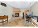 Comfortable living room featuring a stone fireplace and hearth with rustic tile flooring at 1673 Woodmoor Dr, Monument, CO 80132