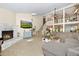 Open-concept living area featuring a brick fireplace, high ceilings, and natural lighting at 1673 Woodmoor Dr, Monument, CO 80132