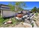Relaxing patio includes a hot tub, seating, grill and dining area, perfect for outdoor entertaining at 1673 Woodmoor Dr, Monument, CO 80132