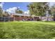 Expansive backyard featuring a well-maintained lawn, brick home, patio, and privacy fence—perfect for outdoor living at 3205 Moorhead Ave, Boulder, CO 80305