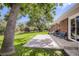 Spacious backyard with a concrete patio, mature trees, and a lush lawn, great for outdoor entertaining at 3205 Moorhead Ave, Boulder, CO 80305