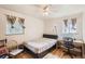 Comfortable bedroom featuring hardwood floors, two windows, and a ceiling fan, ideal for restful nights at 3205 Moorhead Ave, Boulder, CO 80305