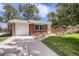 Charming red brick home featuring a one-car garage and a well-manicured lawn under a sunny, partly cloudy sky at 3205 Moorhead Ave, Boulder, CO 80305