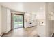 Bright kitchen features white cabinets, countertops, and appliances, with a sliding glass door to the backyard at 3205 Moorhead Ave, Boulder, CO 80305