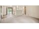 Open living space with white walls, new carpet, and an adjoining kitchen area with white cabinets and modern appliances at 3205 Moorhead Ave, Boulder, CO 80305