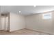 Finished basement with neutral carpet, recessed lighting, and a small window at 3770 Osceola St, Denver, CO 80212