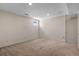 A finished basement with neutral carpet, recessed lighting, and a small window at 3770 Osceola St, Denver, CO 80212