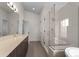 Modern bathroom featuring a glass enclosed shower and double sink vanity with clean, neutral tile work at 3770 Osceola St, Denver, CO 80212