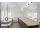 Spa-like bathroom features soaking tub, dual vanities, and frameless glass shower at 3770 Osceola St, Denver, CO 80212