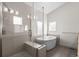 Spa-like bathroom features soaking tub, dual vanities, and frameless glass shower at 3770 Osceola St, Denver, CO 80212