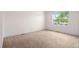 Bright, carpeted bedroom with a large window offering plenty of natural light and neutral paint at 3770 Osceola St, Denver, CO 80212