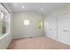 An empty bedroom with neutral carpet, two windows letting in natural light, and a large closet at 3770 Osceola St, Denver, CO 80212
