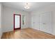 Bright bedroom with light hardwood floors, access door and double closets with modern lighting at 3770 Osceola St, Denver, CO 80212