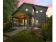 Inviting two-story home featuring a covered front porch and manicured lawn at dusk at 3770 Osceola St, Denver, CO 80212