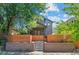 Attractive two-story home with a wooden fence and meticulous stone work in the landscaping at 3770 Osceola St, Denver, CO 80212