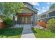 Inviting two-story home featuring a covered front porch and manicured lawn at 3770 Osceola St, Denver, CO 80212