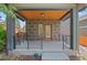 Inviting front porch featuring neutral stone columns, detailed ceiling and classic red door at 3770 Osceola St, Denver, CO 80212
