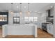 Bright kitchen features large island, stainless appliances, and modern fixtures with ample counter space at 3770 Osceola St, Denver, CO 80212
