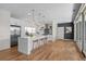 Modern kitchen featuring a large island, stainless steel appliances, and pendant lighting at 3770 Osceola St, Denver, CO 80212