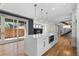 Bright open kitchen features large island, stainless appliances, modern lighting and access to fenced outdoor space at 3770 Osceola St, Denver, CO 80212