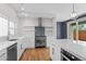 Modern kitchen featuring stainless steel appliances, white cabinetry, and a stylish island with seating and views at 3770 Osceola St, Denver, CO 80212