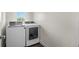 Bright laundry room with stacked washer and dryer, and a window providing natural light at 3770 Osceola St, Denver, CO 80212