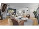 Bright living room with hardwood floors flowing into the open kitchen and dining area at 3770 Osceola St, Denver, CO 80212
