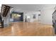 Spacious living room showcasing modern staircase, large windows, and seamless flow into the stylish white kitchen at 3770 Osceola St, Denver, CO 80212