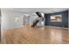 Expansive living area with hardwood floors, modern staircase, and seamless transition to other living spaces at 3770 Osceola St, Denver, CO 80212