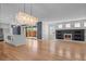 Open living space with hardwood floors, modern fireplace, and direct access to the sleek white kitchen at 3770 Osceola St, Denver, CO 80212