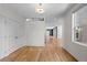 Spacious open-concept living area featuring gleaming hardwood floors and abundant natural light at 3770 Osceola St, Denver, CO 80212