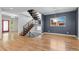 Stylish living area features hardwood floors, a modern staircase, and large windows for ample natural light at 3770 Osceola St, Denver, CO 80212