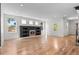 Bright living room with hardwood floors, modern fireplace, ample natural light from multiple windows at 3770 Osceola St, Denver, CO 80212