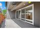 A view of the outdoor patio featuring sliding glass doors and a concrete floor with a view of the yard at 3770 Osceola St, Denver, CO 80212