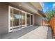 A view of the outdoor patio featuring sliding glass doors and a concrete floor, perfect for entertaining at 3770 Osceola St, Denver, CO 80212