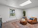 Cozy basement space with two comfortable lounge chairs and scenic natural light at 11650 Baca Rd, Conifer, CO 80433