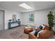 Basement living space with comfortable brown leather lounge seating and stylish decor at 11650 Baca Rd, Conifer, CO 80433