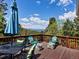 Enjoy outdoor living on this deck with mountain views, stylish seating, and an umbrella-covered table at 11650 Baca Rd, Conifer, CO 80433
